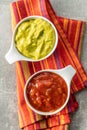 Sauces in bowl. Guacamole and tomato dip in bowl