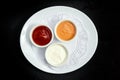Sauces on a plate, ketchup, mayonnaise and mustard