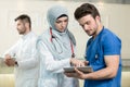 Saudi arab doctors working with a tablet. Royalty Free Stock Photo