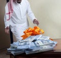 Saudi Arab man surprized with stacks of money on the table Royalty Free Stock Photo