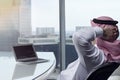 Saudi Arab Man Watching Laptop at Work Contemplating Royalty Free Stock Photo