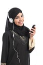 Saudi arab woman listening to the music from a smart phone