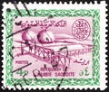 SAUDI ARABIA - CIRCA 1966: A stamp printed in Saudi Arabia shows Gas Oil Plant Cartouche of King Saud, circa 1966.