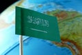 Saudi Arabia flag with a globe map as a background Royalty Free Stock Photo
