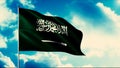 Saudi Arabia flag waving in the wind on a flagpole, seamless loop. Motion. Highly detailed fabric texture on a blue sky Royalty Free Stock Photo