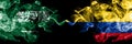 Saudi Arabia Kingdom vs Colombia, Colombian smoky mystic flags placed side by side. Thick colored silky smoke flags of Arabic,