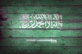 Saudi Arabia national flag on wooden rustic background. Royalty Free Stock Photo