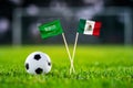 Saudi Arabia vs. Mexico, Lusail, Football match wallpaper, Handmade national flags and soccer ball on green grass. Football Royalty Free Stock Photo