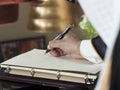 Saudi Arabian Man Hand Writing on A Notebook