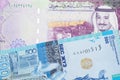 Saudi Arabian money with a blue tenge note from Kazakhstan