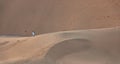 A Saudi couple take a selfie in the huge sand dunes in Badr, Medina, Saudi Arabia