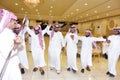 Saudi men celebrating and enjoying traditional dance with cultural objects