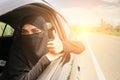 Saudi Woman Driving a Car on the road.