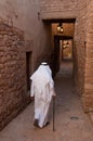 Saudian walking inside the walls of Al-Ula Old City, Saudi Arabi