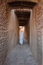 Saudian walking inside the walls of Al-Ula Old City, Saudi Arabia Royalty Free Stock Photo
