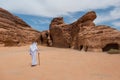 Saudian walking in MadaÃÂ®n Saleh archeological site, Saudi Arabi