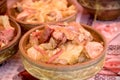 Sauerkraut - cabbage with smoked knuckle, ham hock, pork knees, pork shoulder in earthy bowl on table