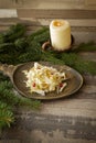 Sauerkraut with cowberries in wooden plate, is traditional dish of Belarus for winter time