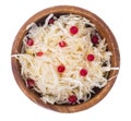 Sauerkraut with cranberries in wooden bowl on white background