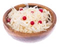 Sauerkraut with cranberries in wooden bowl on white background