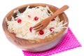 Sauerkraut with cranberries in wooden bowl on white background