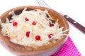 Sauerkraut with cranberries in wooden bowl on white background