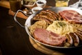 Sauerkraut pan with small fried Bavarian German NÃÂ¼rnberger sausages, smoked Kassler pork neck, mashed potatoes, mustard and spice Royalty Free Stock Photo