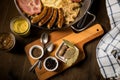 Sauerkraut pan with small fried Bavarian German NÃÂ¼rnberger sausages, smoked Kassler pork neck, mashed potatoes, mustard and spice Royalty Free Stock Photo