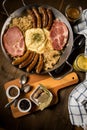 Sauerkraut pan with small fried Bavarian German NÃÂ¼rnberger sausages, smoked Kassler pork neck, mashed potatoes, mustard and spice Royalty Free Stock Photo