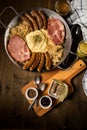 Sauerkraut pan with small fried Bavarian German NÃÂ¼rnberger sausages, smoked Kassler pork neck, mashed potatoes, mustard and spice Royalty Free Stock Photo