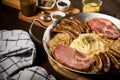 Sauerkraut pan with small fried Bavarian German NÃÂ¼rnberger sausages, smoked Kassler pork neck, mashed potatoes, mustard and spice Royalty Free Stock Photo