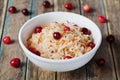 Sauerkraut or sour cabbage with cranberries in a white bowl on rustic wooden table Royalty Free Stock Photo