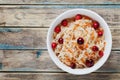 Sauerkraut or sour cabbage with cranberries in a white bowl on rustic wooden table Royalty Free Stock Photo