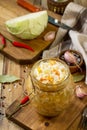 Sauerkraut variety preserving jars. Homemade Sauerkraut with Carrot on a wooden table.