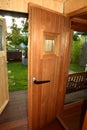 Sauna cabin with opened door with look to wellness area Royalty Free Stock Photo