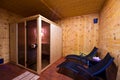 Sauna interior with two sunbeds and cherry wood walls