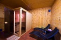 Sauna interior with two sunbeds and cherry wood walls Royalty Free Stock Photo