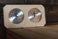 Sauna thermometer and hygrometer on the wooden bench