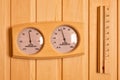 Sauna thermometer and hygrometer on wooden wall. Temperature in celsius