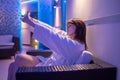 Young dark-haired woman spending time in sauna Royalty Free Stock Photo