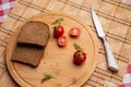 Tomates with black bread for lunch, Black bread with tomato on the wooden background Royalty Free Stock Photo