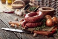 Sausage with bread and spices on a old wooden table Royalty Free Stock Photo