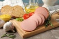 Sausage, bread, spices, towel and board on background, close up Royalty Free Stock Photo