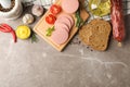 Sausage, bread, spices, towel and board on background, space for text Royalty Free Stock Photo