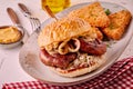 Sausage burger with onion served on plate