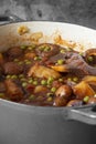 Sausage casserole in a casserole dish, with potato, mushrooms, tomatoes, peas and onion, in a beef stock Royalty Free Stock Photo