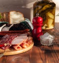 Sausage cutting still life on a wooden table. Festive table with a snack