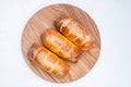 Sausage in dough close on a wooden plate. top view Isolated Royalty Free Stock Photo