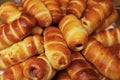 Sausage in dough or hotdog close-up. Lots of fresh pastries made of puff pastry and sausage. Top view. Background Royalty Free Stock Photo