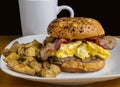 sausage and egg breakfast sandwich with home fries